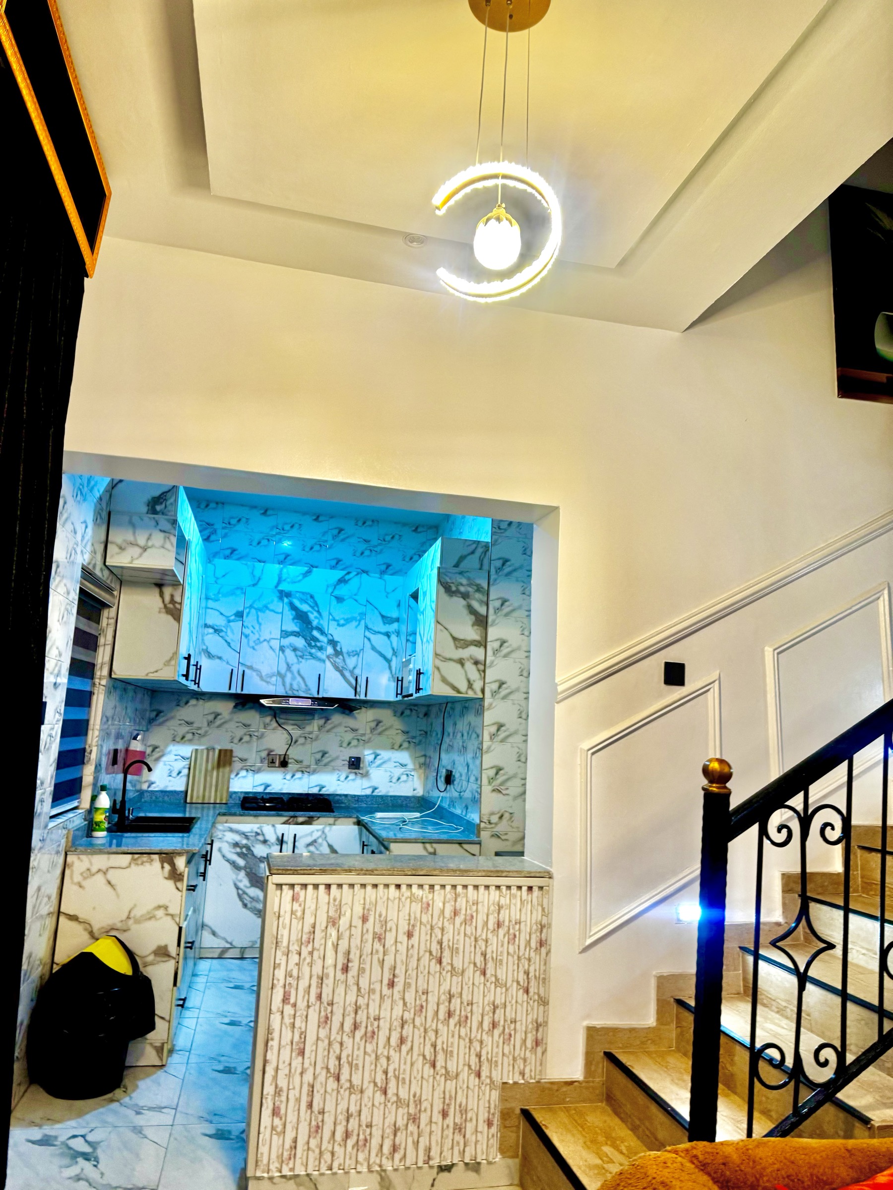 Living area with TV wall and yellow chair